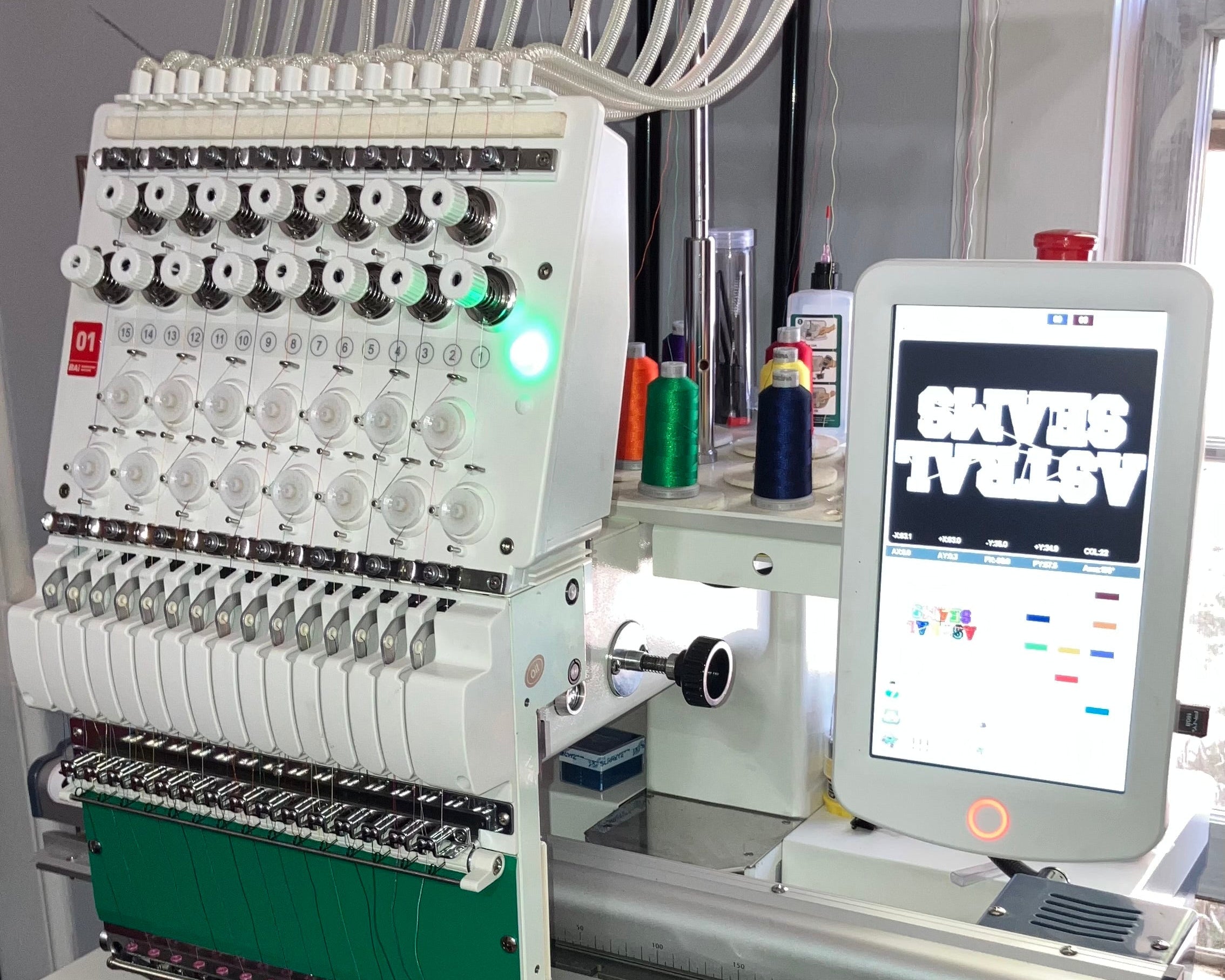 Embroidery machine with digital display on a stand